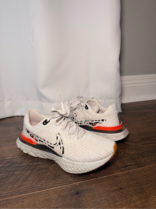 Nike Shoes - **NWOT** Nike White Flyknit Running Shoes with Black and Orange Accents